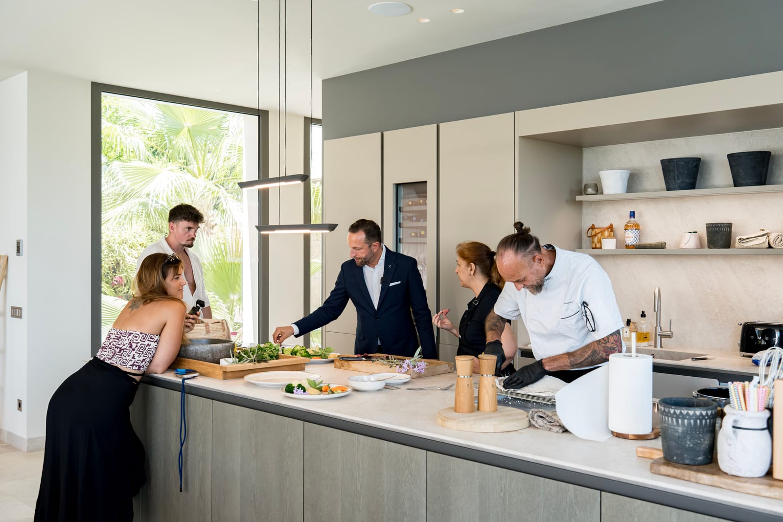 Butler school training class around a kitchen island