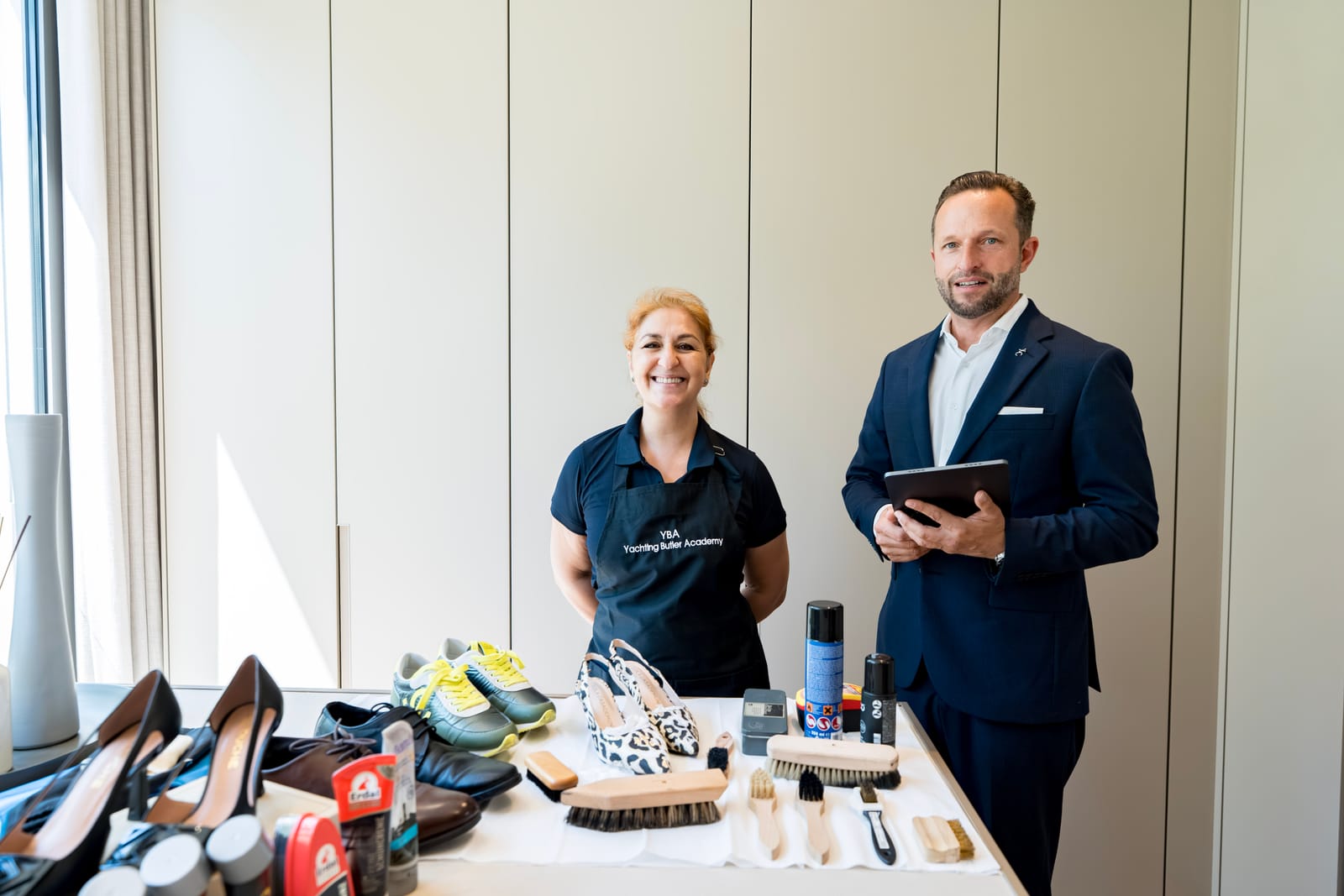 Butler and trainer at a shoe-care station