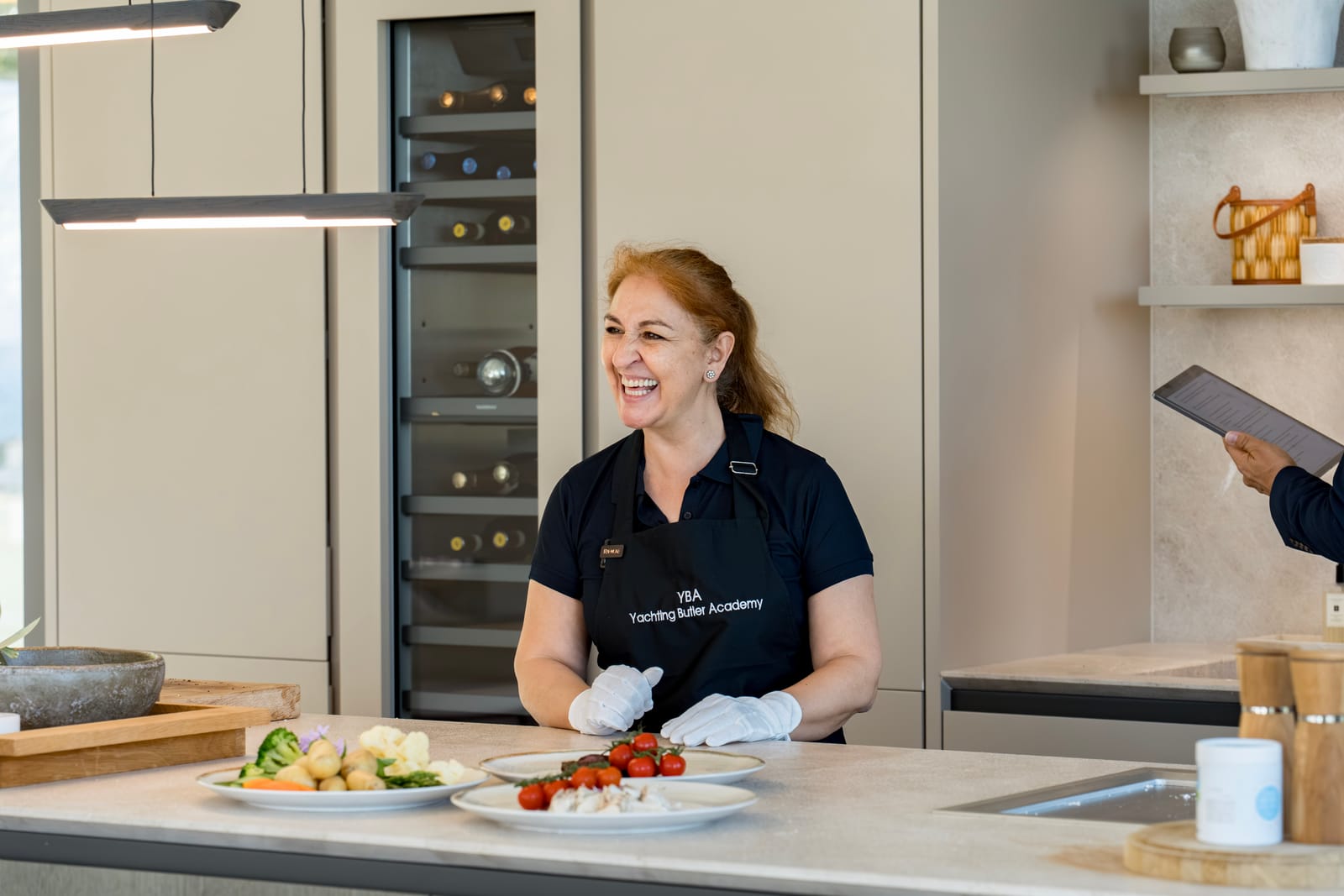 Gloved server plating food for silver service