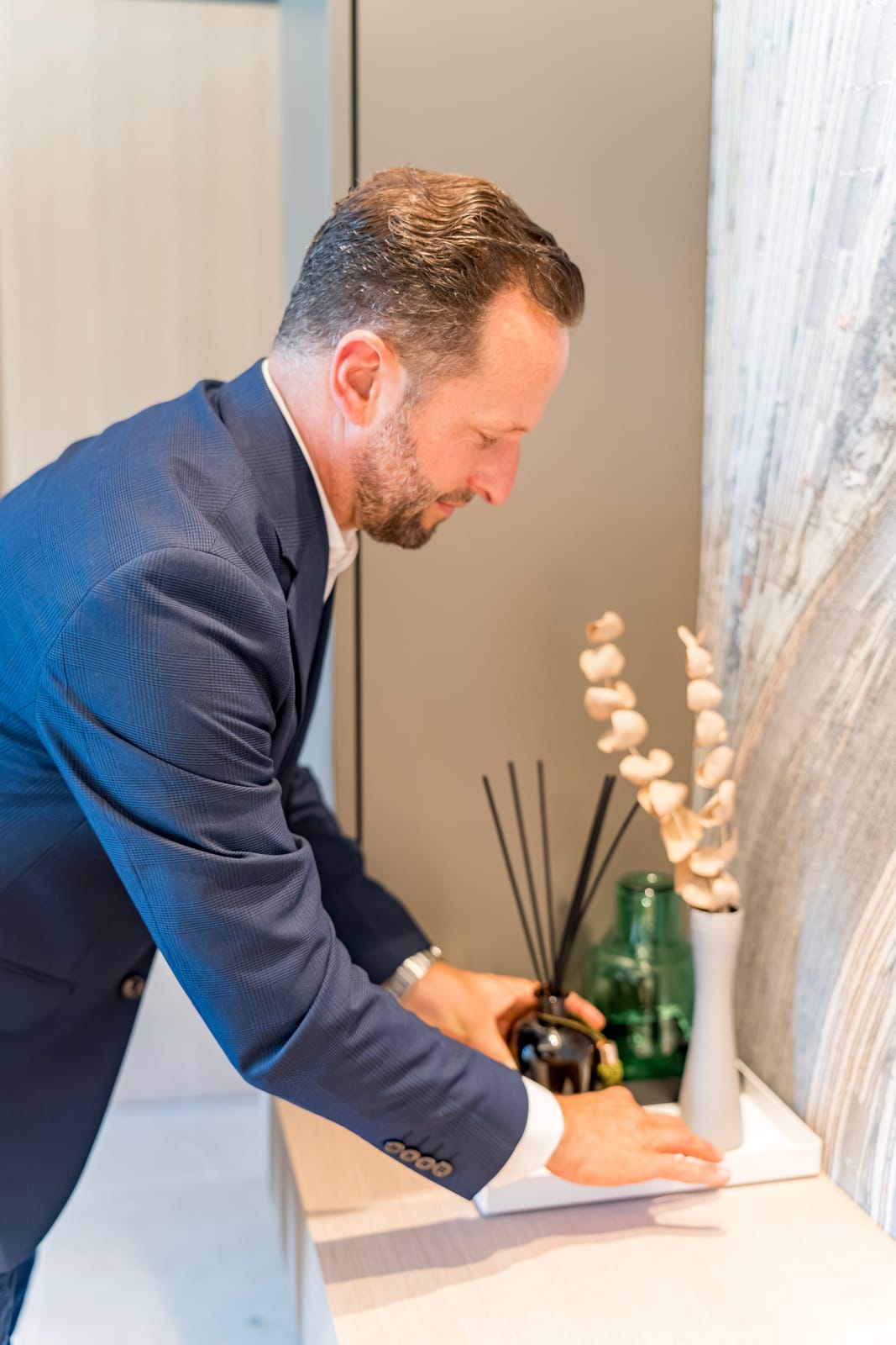 Butler writing a guest welcome note at a console